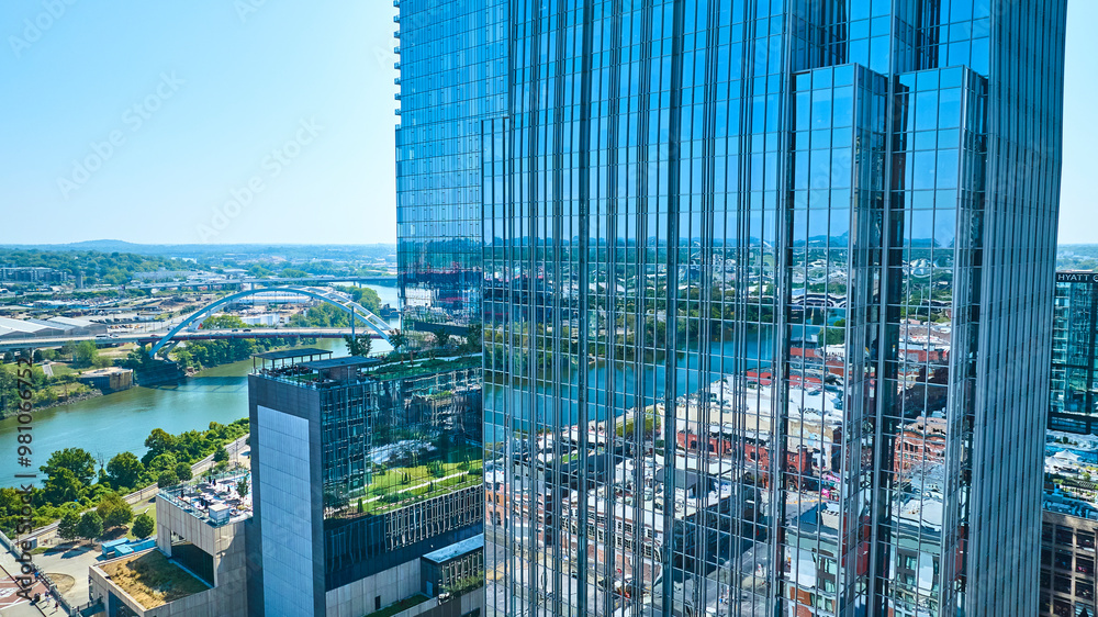 Fototapeta premium Aerial View of Glass Skyscraper and River in Downtown Nashville