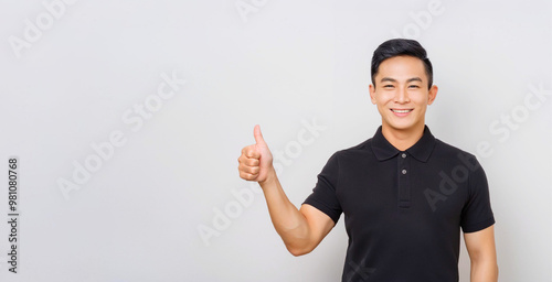 A portrait of a man wearing a black polo shirt giving a thumbs up.