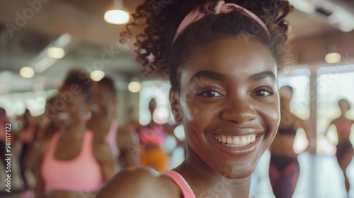 A woman stands with a smile, possibly after working out or feeling proud of her fitness achievement