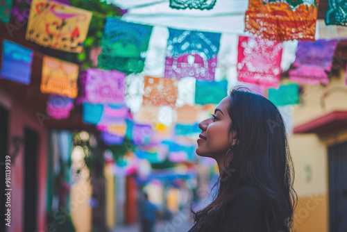 Latin woman enjoying colorful street decorations. Urban photography in Oaxaca, Mexico.