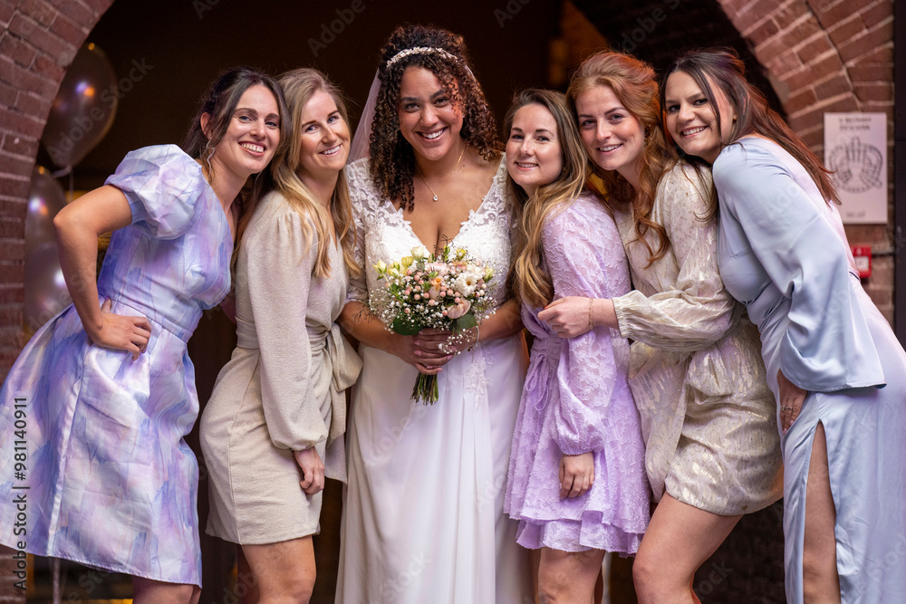 Bride in white dress holding a bouquet surrounded by four bridesmaids in pastel dresses, smiling together at a wedding celebration. Bride in white dress holding a bouquet surrounded by four bridesmaids in pastel dresses, smiling together at a wedding celebration.