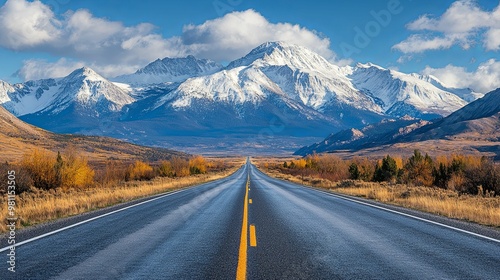 A Straight Road Leading to Snow-Capped Mountains