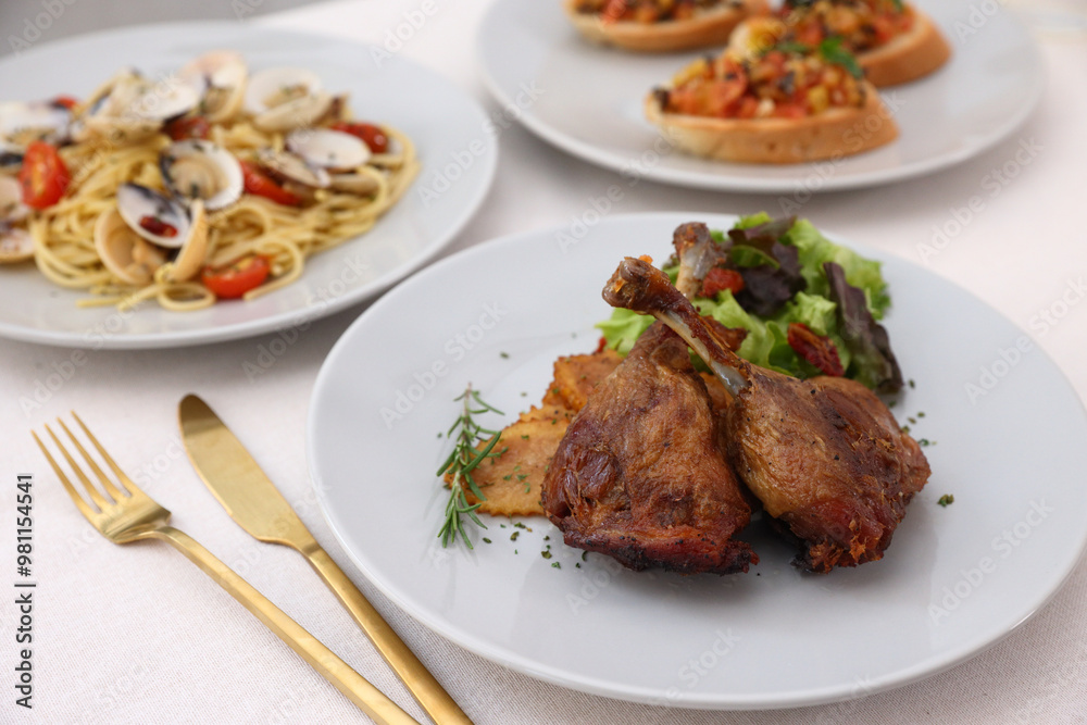Duck leg confit with sauce. isolate in white background. top view. Duck confit on white plate Duck leg confit with sauce. isolate in white background. top view. Duck confit on white plate