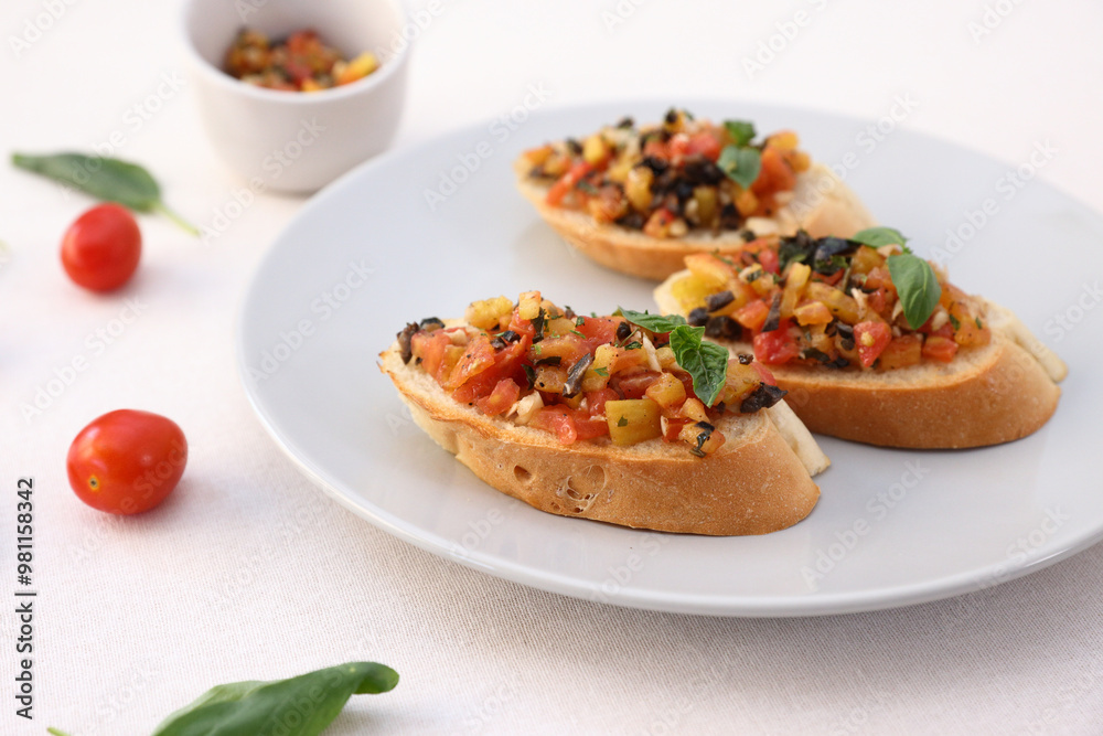 Bruschetta with Tomato and Basil Traditional toasted Italian food tomato bruschetta seasoned with spice and garnished with basil