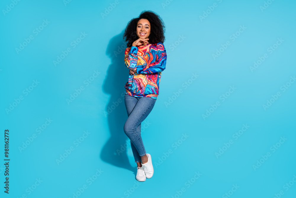 Full body photo of attractive young woman minded toothy smile dressed stylish colorful clothes isolated on blue color background Full body photo of attractive young woman minded toothy smile dressed stylish colorful clothes isolated on blue color background