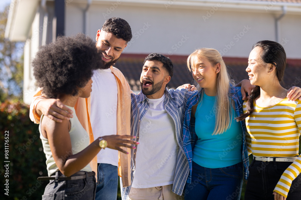 Group of young friends standing together outdoors, smiling and talking Group of young friends standing together outdoors, smiling and talking
