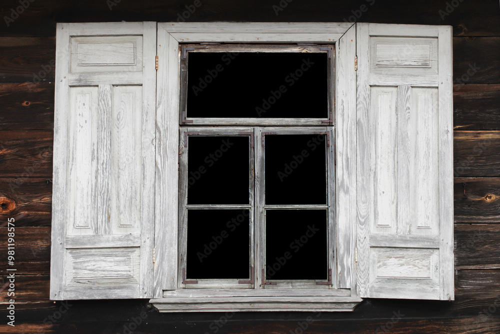 Fototapeta premium Old wooden window with peeling white paint in rustic architecture. Shutters with worn paint. Empty window in a rural wooden house. Weathered and aged design on a country home.