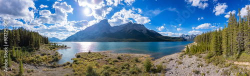 Breathtaking Panorama of the Canadian Rockies with Lush Forests and Crystal Clear Lake