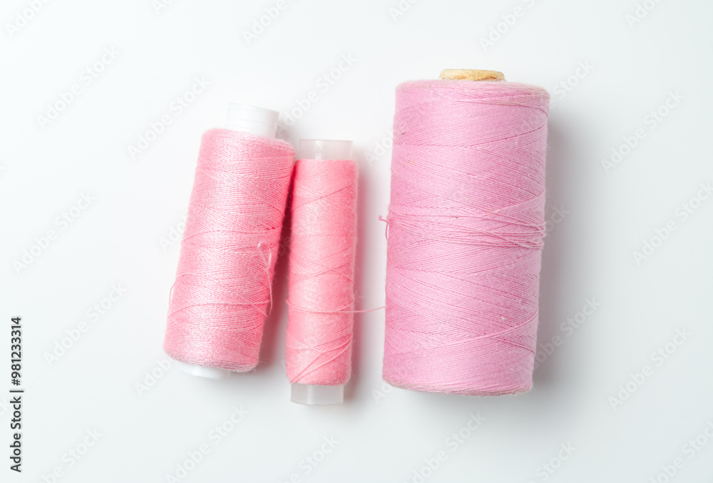 Pink thread spools on white background. Pink thread spools on white background.