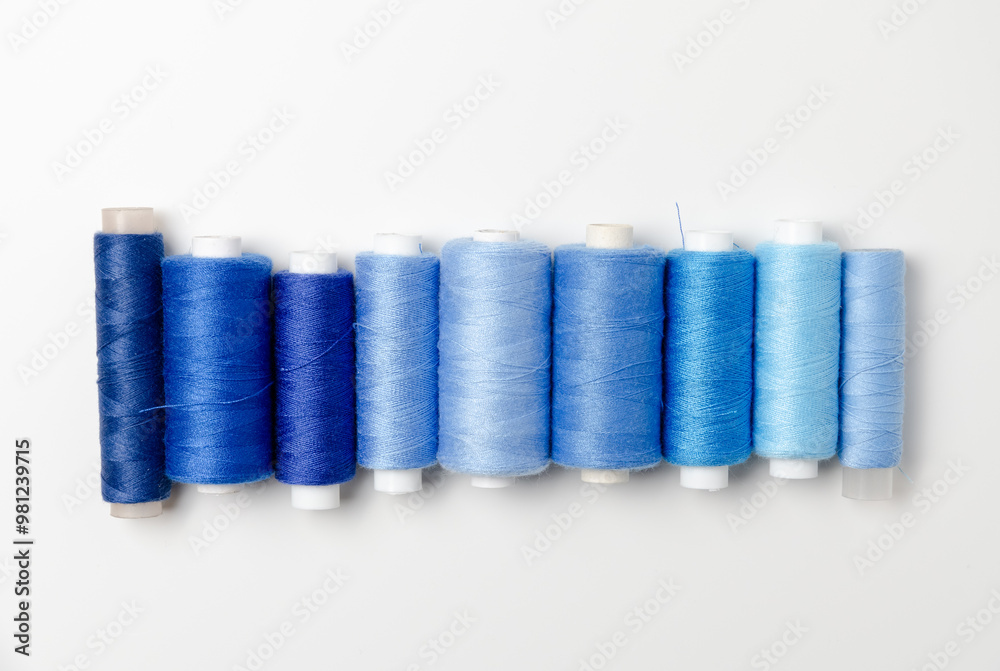 Blue thread spools on white background. Blue thread spools on white background.