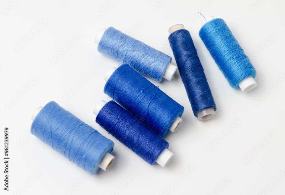 Blue thread spools on white background. Blue thread spools on white background.