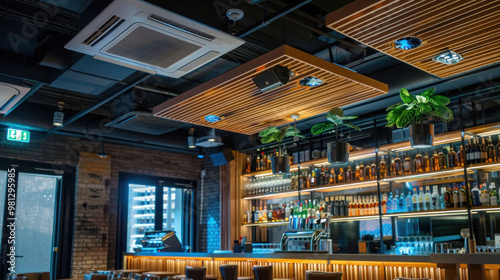 Modern restaurant interior with wooden ceiling panels, ambient lighting, and well stocked bar. design features plants and cozy atmosphere, perfect for dining