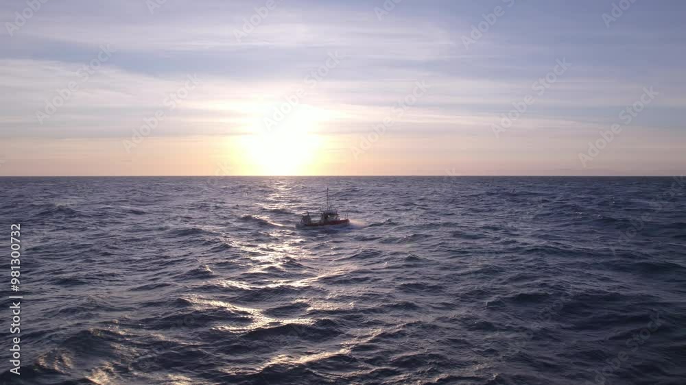 Lone Boat Sailing Against A Stunning Sunrise Lone Boat Sailing Against A Stunning Sunrise