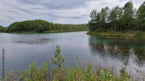 Beautiful calm green lake on a summer day.