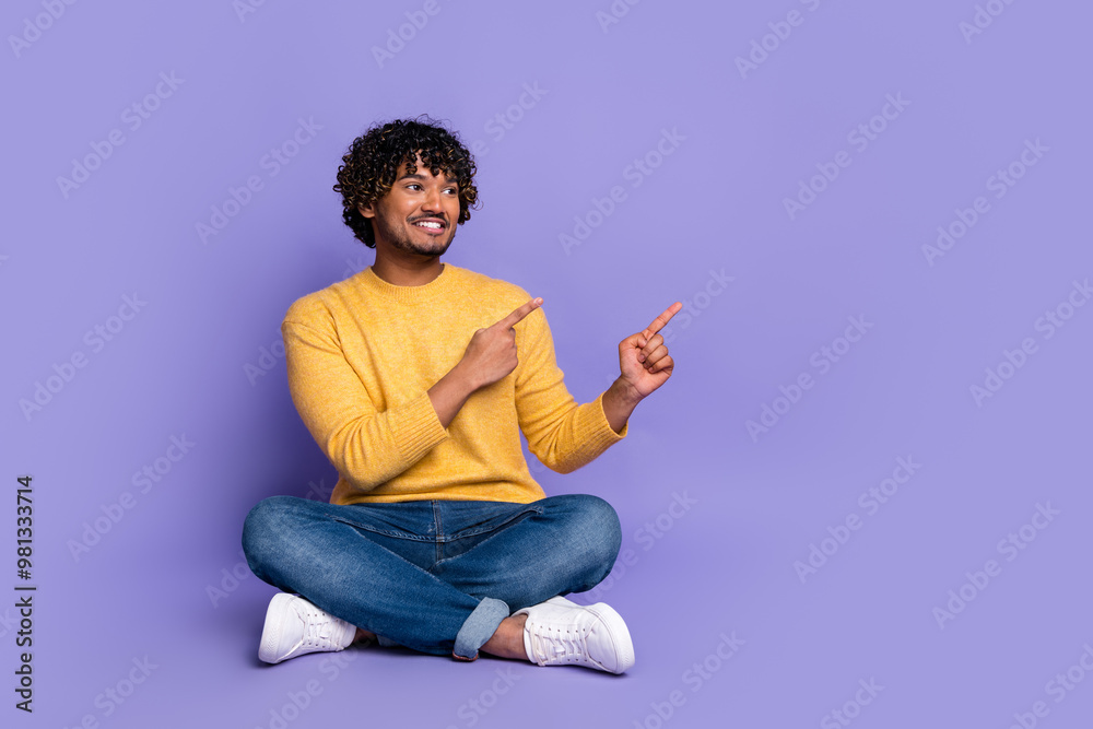 Photo of positive nice man wear trendy yellow clothes demonstrate recommend empty space isolated on purple color background Photo of positive nice man wear trendy yellow clothes demonstrate recommend empty space isolated on purple color background
