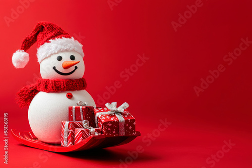 Snowman with Christmas gifts on the sledge isolated on red background