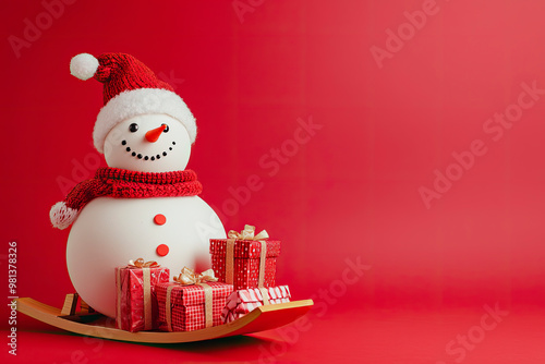 Snowman with Christmas gifts on the sledge isolated on red background