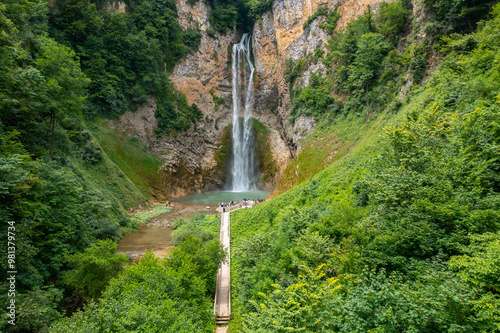 A beautiful waterfall with a wooden path to it surrounded by greenery - Bliha waterfall near Sanski Most in Bosnia and Herzegovina