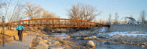 Canvas Print male cyclist is riding a bike in winter sunset scenery - Poudre River Trail in F