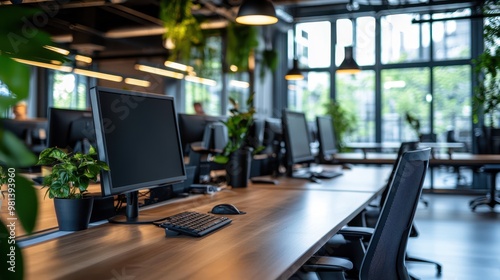 Modern office workspace featuring sleek desks, computers, and greenery, Ideal for illustrating corporate environments, productivity, or office design concepts