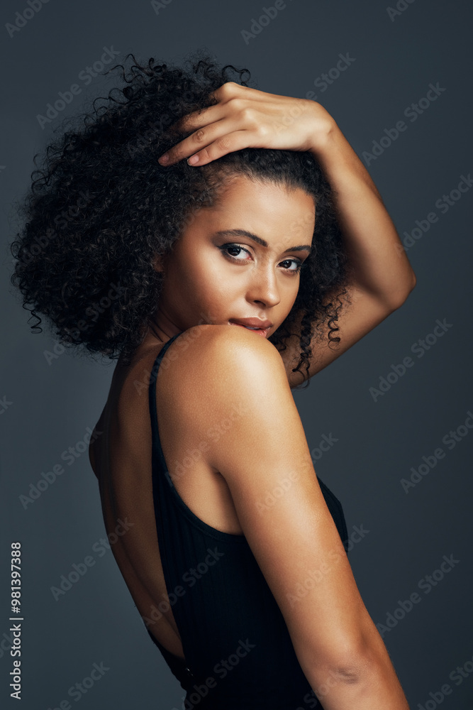 Naklejka premium Woman, portrait and confidence with haircare in studio for natural hair treatment, healthy shine and beauty. African model, person and cosmetics with curls maintenance and growth on gray background