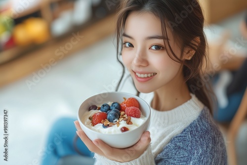 Asian woman eating yogurt for healthy breakfast at home in the morning