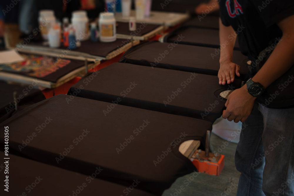 Fototapeta premium Black shirts laying flat on a printing table
