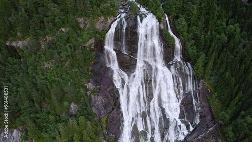 Drone Over Furebergsfossen Waterfall Amidst Towering Pines photo