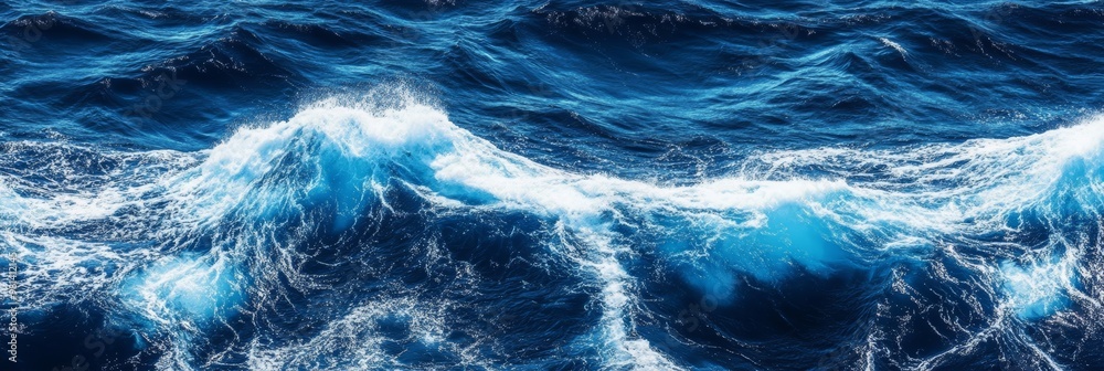 Fototapeta premium Gentle blue waves roll and crash, creating a soothing rhythm along the tranquil waters of a tropical coastline