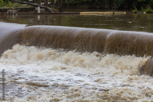 Weir on the Svitava River in the city of Brno, a local part of the Obrany. Big water after rain.