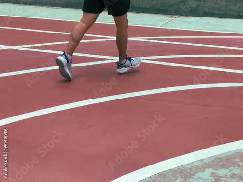 a person running on a red running track