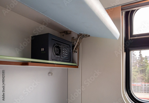 Obraz na plátně A small safe installed in a shelf of a train compartment