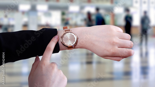 woman looking time at airport