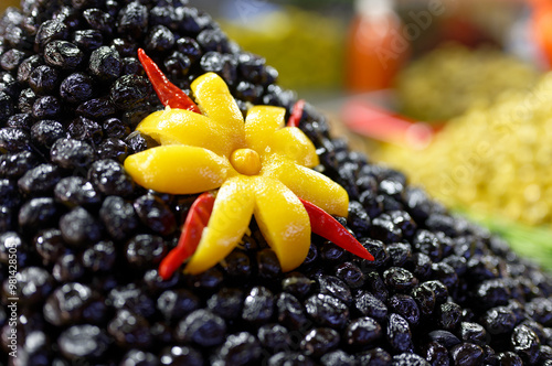 Beautiful composition with a flower made of lemon peel and black olives. Agadir, Morocco, in the bazaar called Souk El Had. photo