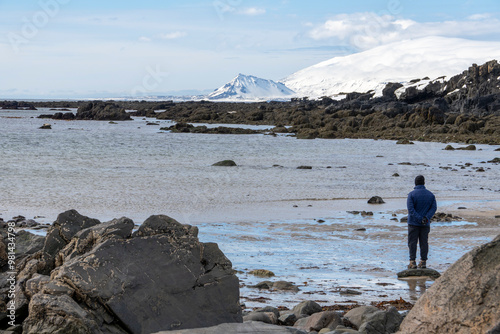 The Snæfellsnes is a peninsula   in western Iceland. Location of Snæfellsnes in Iceland. Road trip  andscape with mountains covered by snow under cloudy sky in Iceland Ytri tunga beach photo