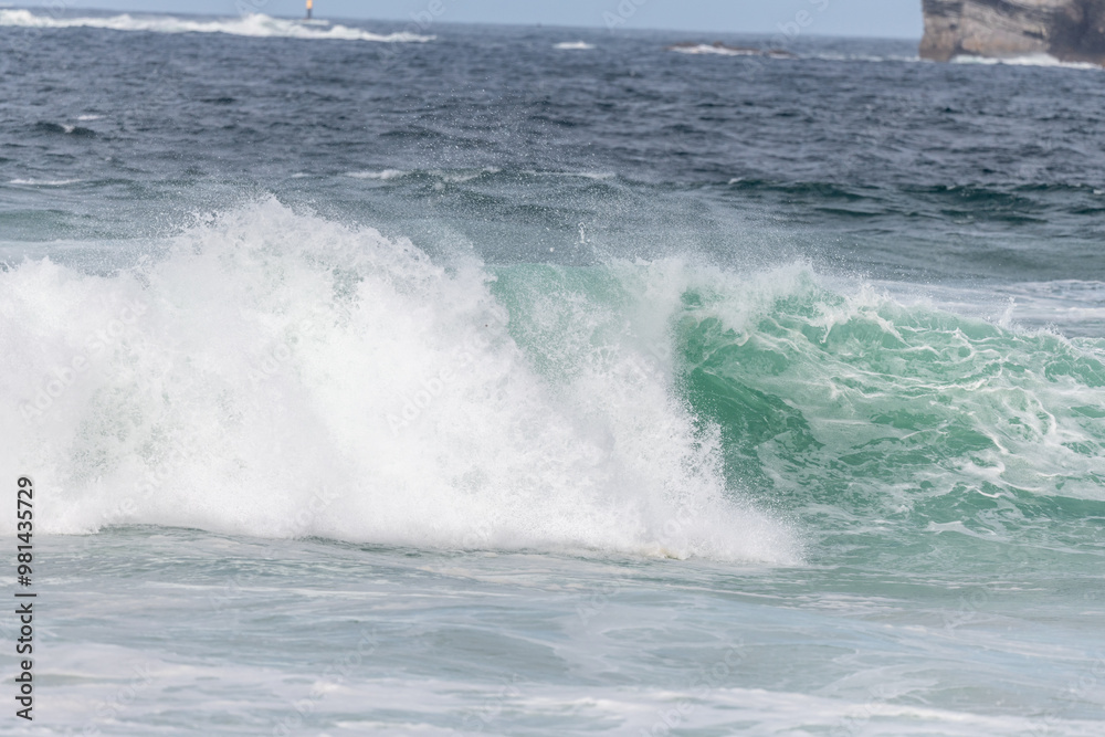Wave of the green and blue Atlantic Ocean at the edge of a beach in the Iroise Sea. Wave of the green and blue Atlantic Ocean at the edge of a beach in the Iroise Sea.