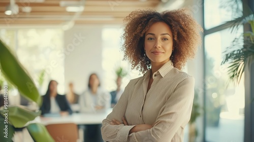 confident businesswoman leading a diverse team meeting in a bright modern openplan office space photo