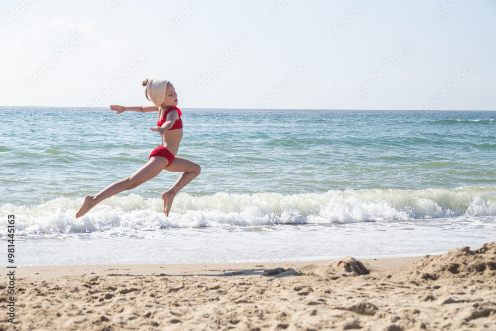 a young rhythmic gymnast trains on the seashore a young rhythmic gymnast trains on the seashore