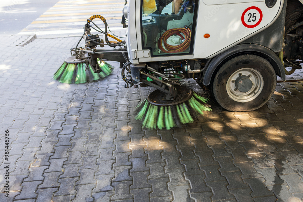 Cleaning up trash in a park using a machine.