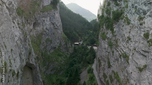 Camera panning over narrow valley with road and buildings photo