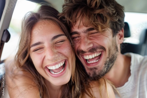 A happy couple smiling together in a car