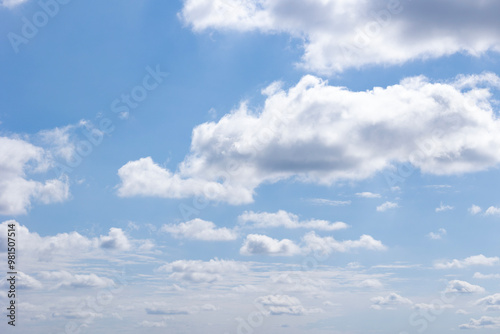 A bright blue sky with fluffy white clouds on a sunny day, inspiring peace and tranquility