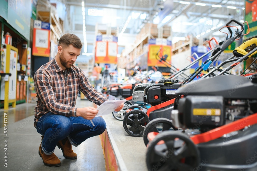 Obraz premium a customer in a hardware store chooses a gas or electric lawn mower