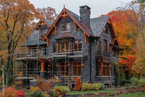 Historic stone mansion undergoing renovation amidst vibrant autumn foliage in a serene neighborhood