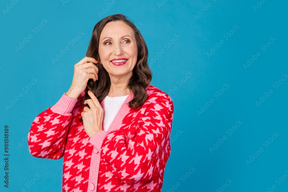 Fototapeta premium Photo portrait of attractive retired woman touch hair look empty space dressed stylish pink print clothes isolated on blue color background