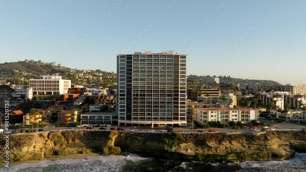 Aerial view of high rise building in La Jolla California overlooking the Children's Pool and Pacific Ocean during golden hour sunset Aerial view of high rise building in La Jolla California overlooking the Children's Pool and Pacific Ocean during golden hour sunset