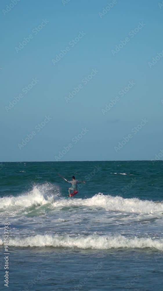 Slow motion, young sporty man kitesurfing in the sea at sunset. Slow motion, young sporty man kitesurfing in the sea at sunset.