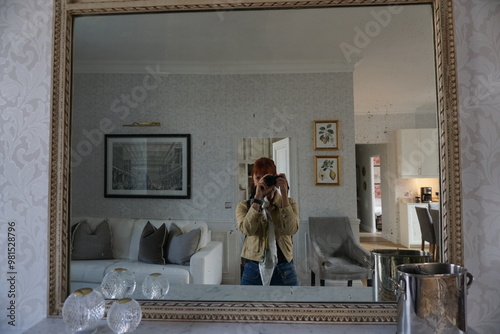 Woman taking a photo of herself in a mirror in Paris