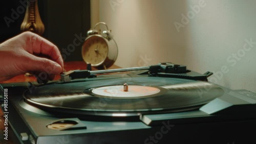 A Vinyl Record Spins Smoothly On A Classic Player Resting On An Antique Dresser, As A Soft Table Lamp Casts A Warm Evening Glow In The Room.