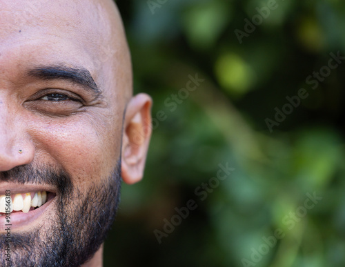 Smiling man with beard enjoying outdoor lifestyle, close-up of face, copy space photo